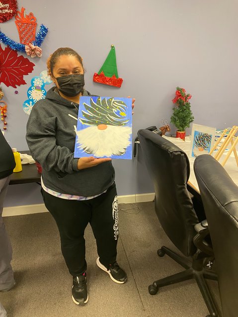 One of the participants of the Parents for Parents support group at Action Toward Independence shows off her winter holiday creation.